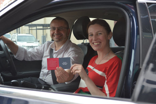 Designated driver vouchers Joe Califore from the TAC handing Emily Bogue a designated driver voucher