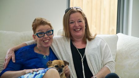 Amanda, her dog, Sally, and mother sitting on couch