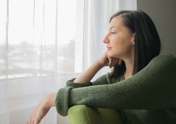 A young woman looking out a window